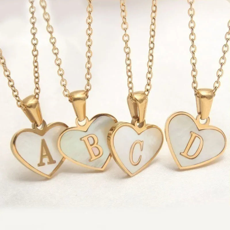 Gold-plated heart necklace with white shell accent and personalised letter pendant on stainless steel chain