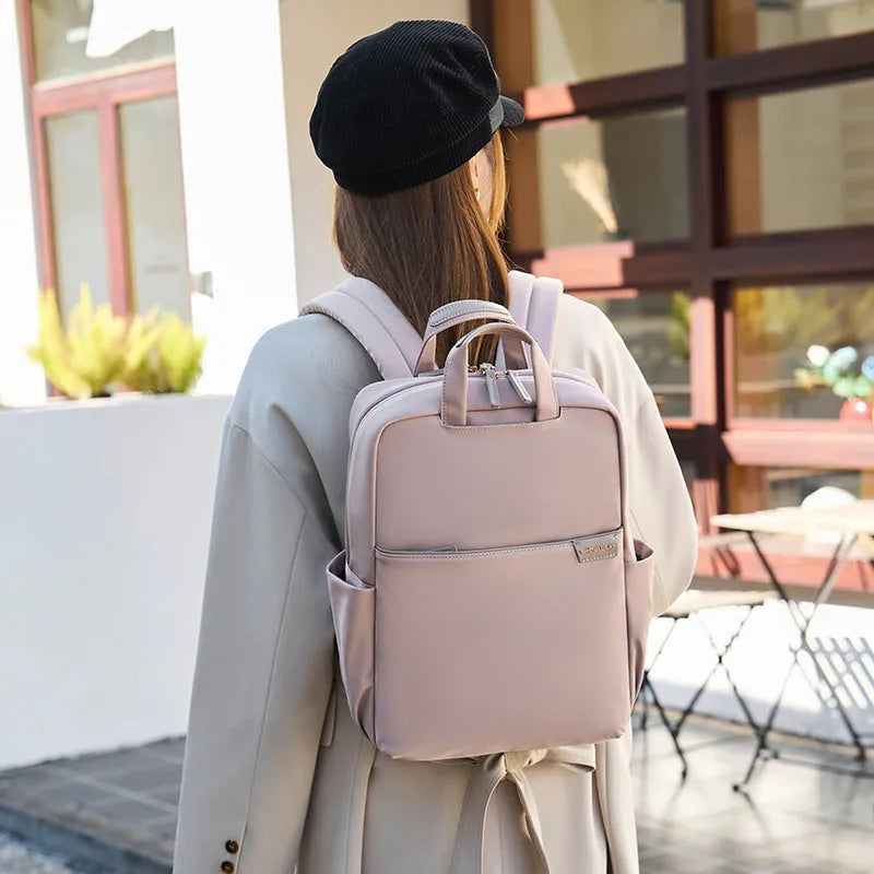 Women's canvas travel backpack in apricot colour showing external sandwich pockets and urban simplicity style.