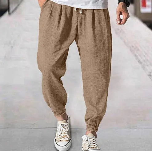Men's casual cotton trousers with ankle bands in light green colour showing loose fit design