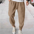 Men's casual cotton trousers with ankle bands in light green colour showing loose fit design