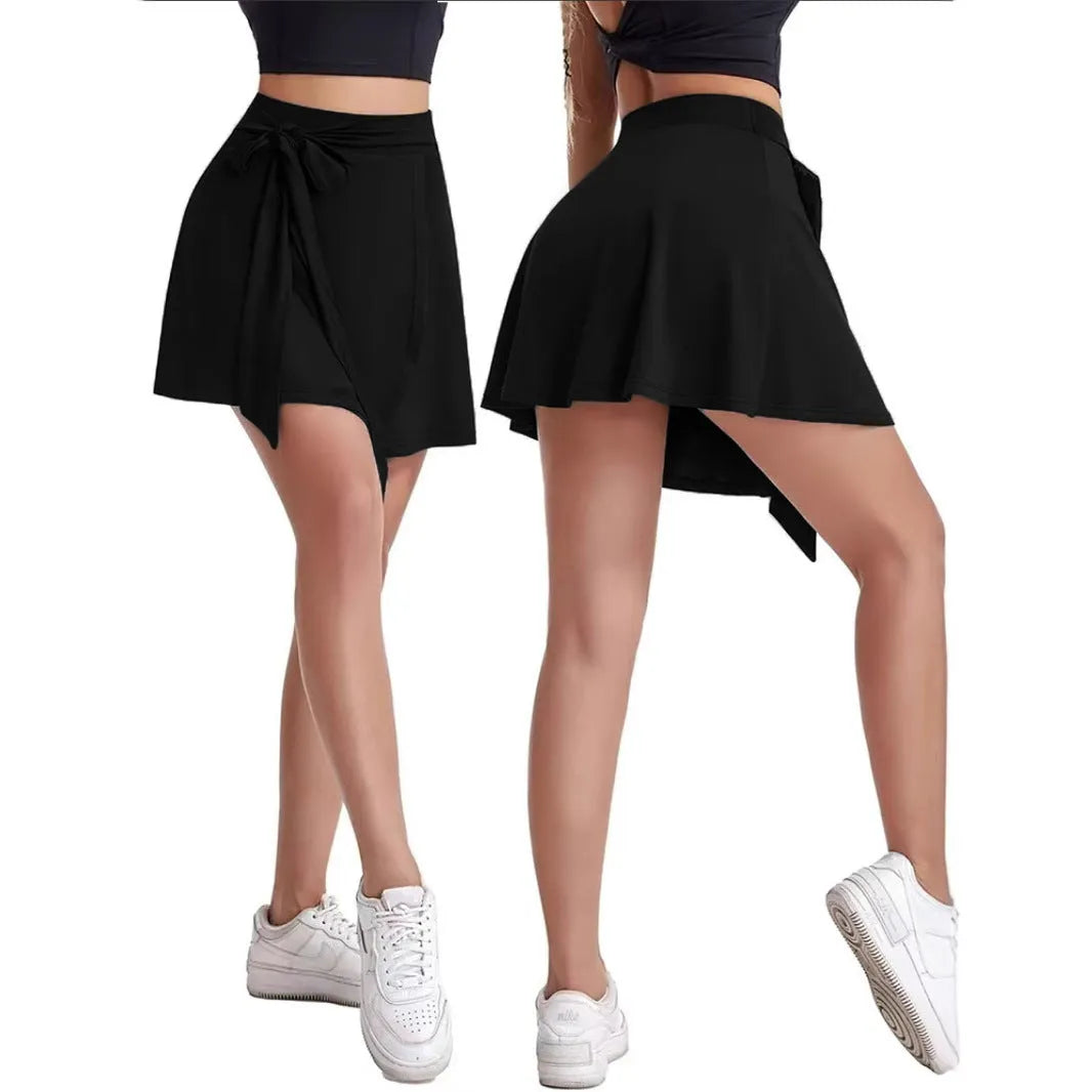 Black thigh-length high-waisted sports culottes with shoulder straps and integrated shorts.