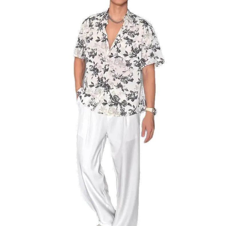 Man's loose-fit short sleeve shirt with printed floral pattern and pendant detail in black