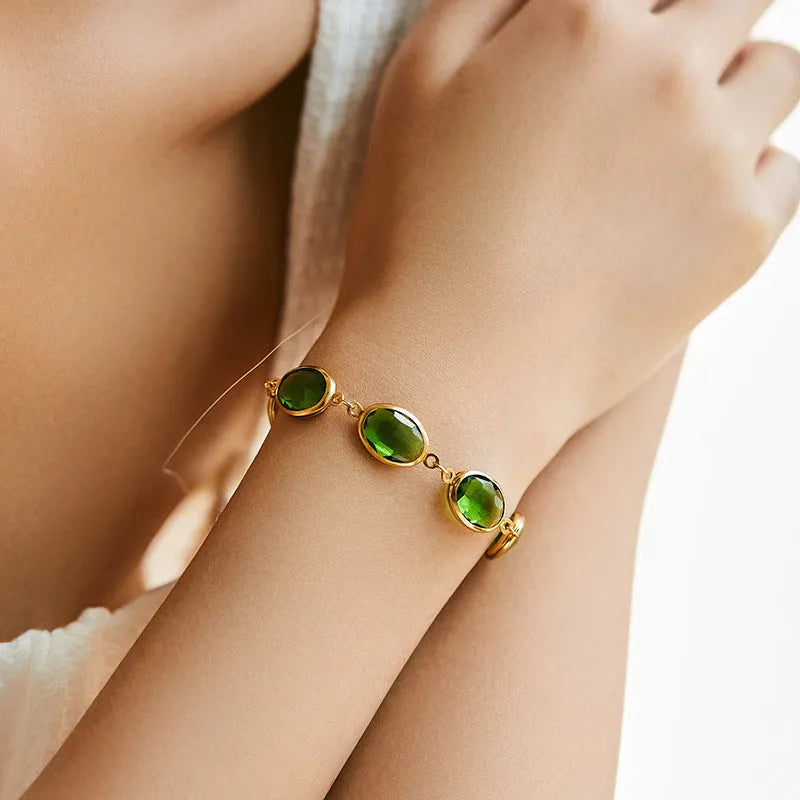 Geometric ellipse women's bracelet with blue glass inlay on an 18K copper band.