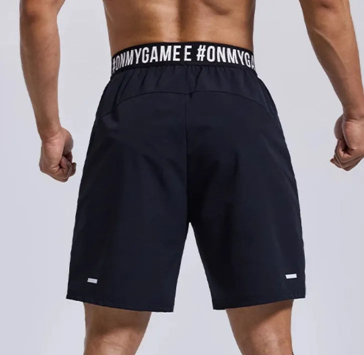 Men's loose sports shorts in black with letter detailing and elastic fly opening