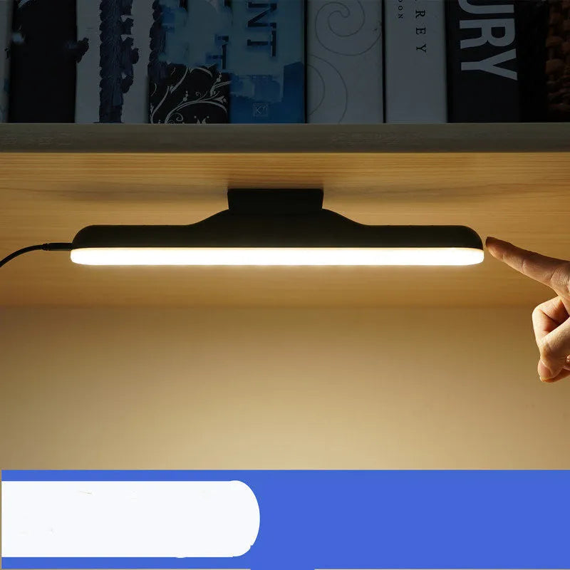 Modern white plastic rechargeable desk lamp with touch-sensitive base for dimming control on a wooden desk.