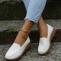 Women's flat loafers in PU leather showing round toe, car suture detail, and a flat rubber sole.