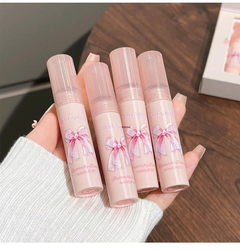 Butterfly Box makeup set containing four pink lip muds, powder blusher and necklace in butterfly packaging