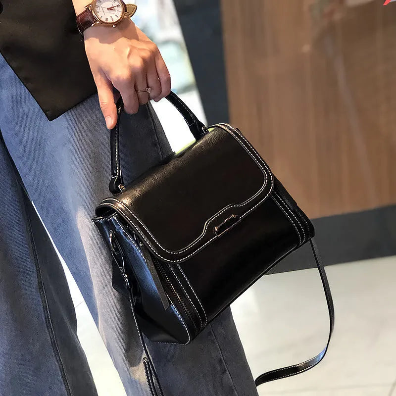 Women's genuine leather messenger bag in retro styling with multiple internal compartments