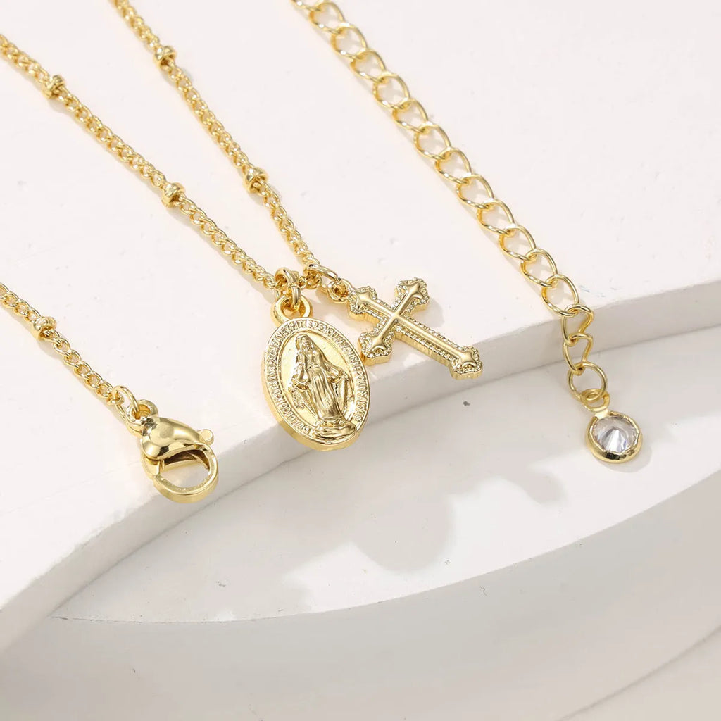 Gold geometric cross Virgin Mary necklace for women on a chain.