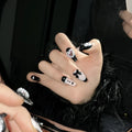 Black and pink peach heart hand-painted press on nails with bow detailing in cat eye gel style