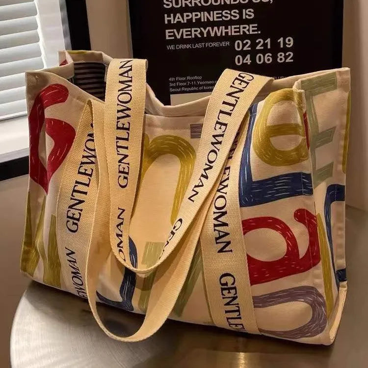 Large canvas tote bag with printing detail in black letters, coloured letters, or pattern style variations