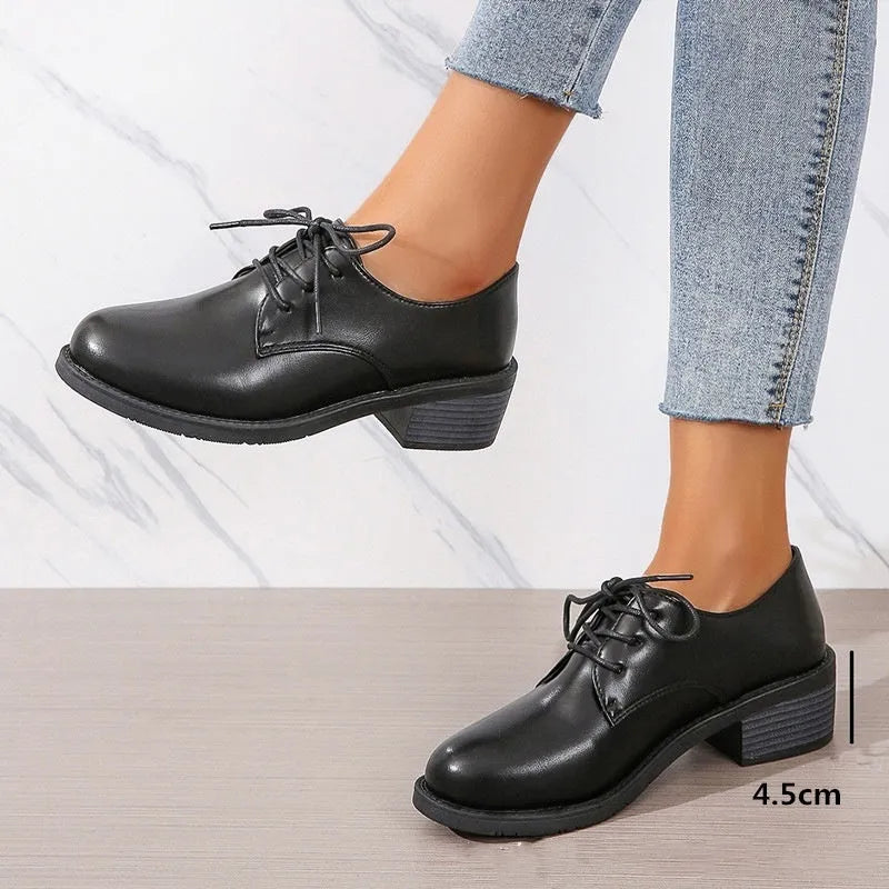 Black women's low-top work shoes with a thick chunky heel and round toe.