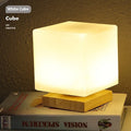 Nordic solid wood USB table lamp with touch dimming in white cube style on wooden surface