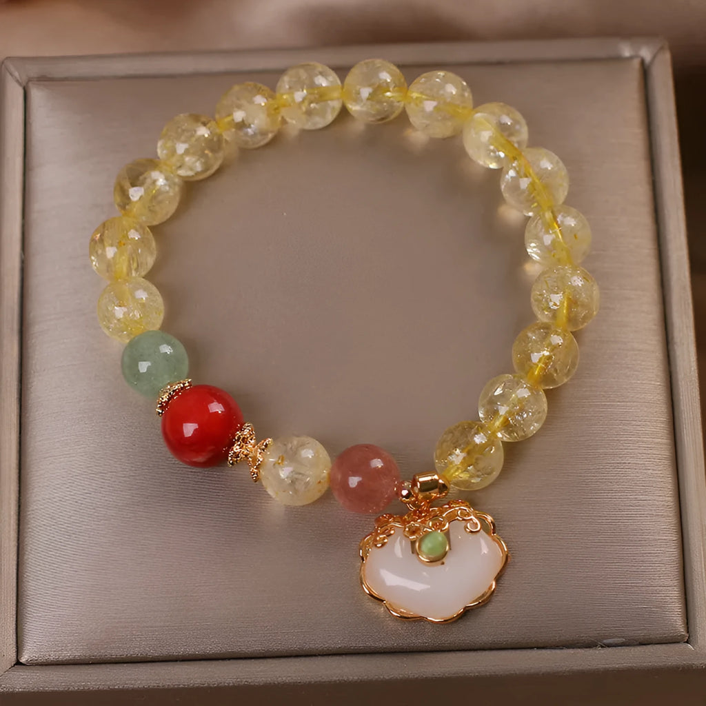 Women's alloy bracelet with a yellow citrine jade ruyi pendant on a white background.