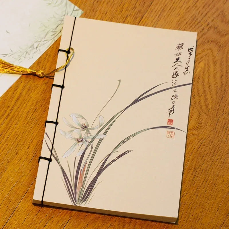 A5 antique wire-bound notebook with retro painting cover, thread binding, and black tassels.