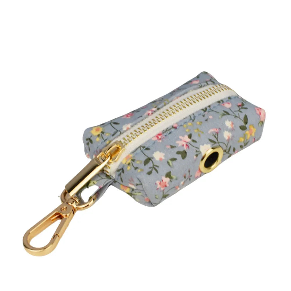 Blue floral patterned cloth dog collar with matching leash, vest, bow, and poop bag set for pet gifts
