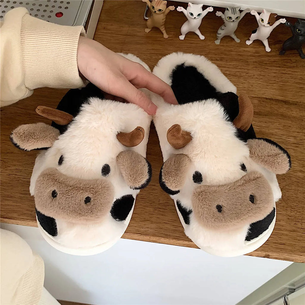 White cow-themed women's plush slippers with faux fur upper and textured non-slip sole
