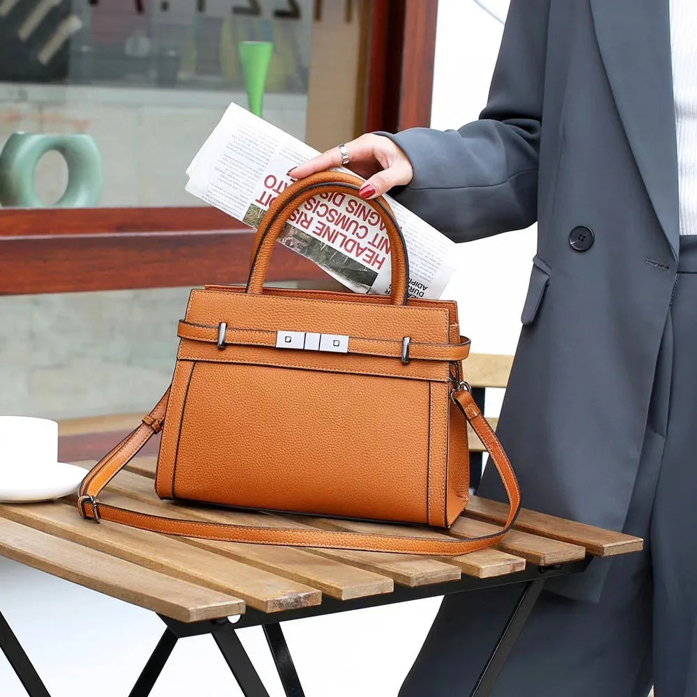 Small square genuine leather shoulder bag in almond green colour showing internal compartments