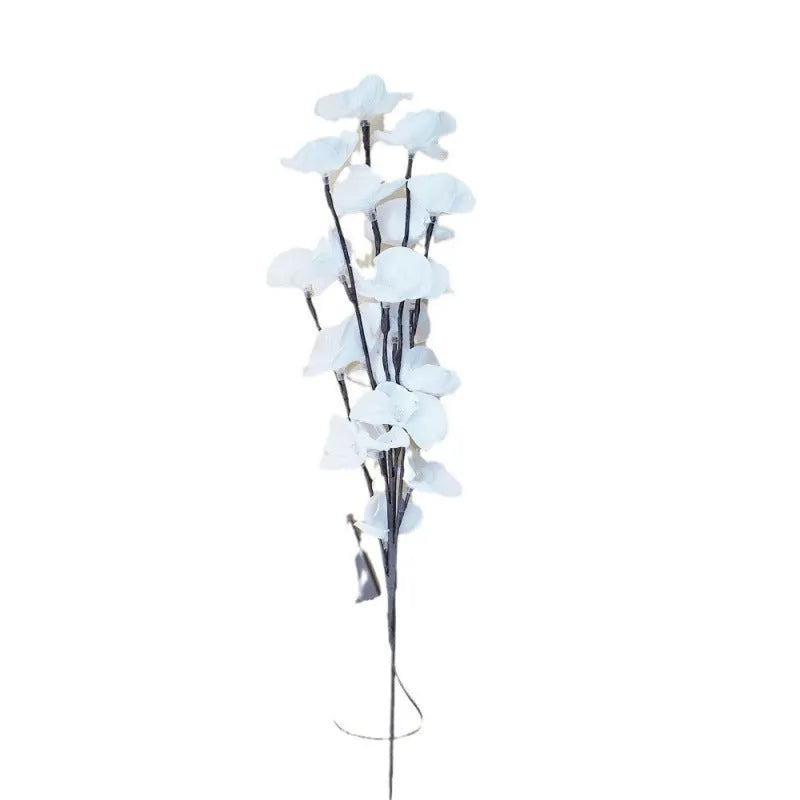 Pink LED phalaenopsis orchid branch decorative light on a dark surface.
