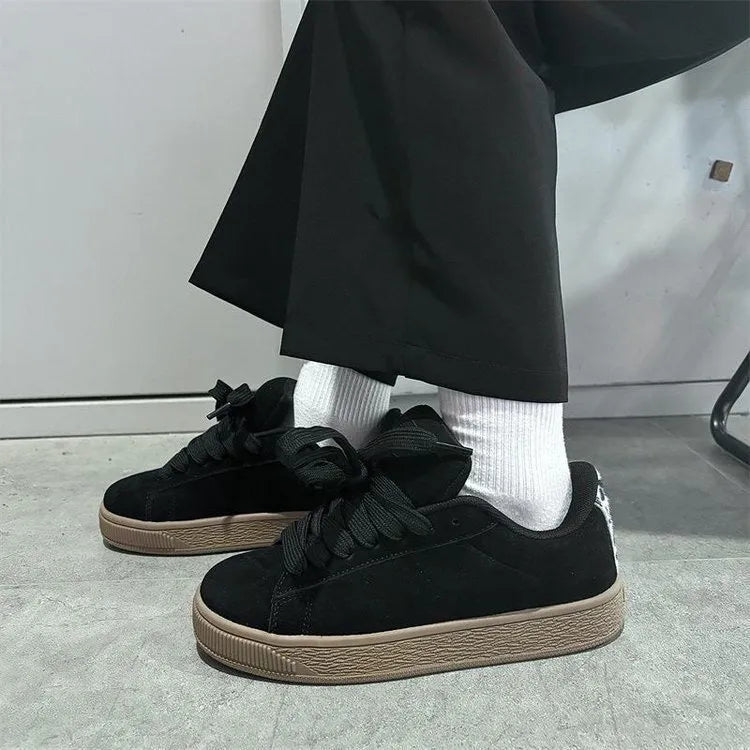 Black retro low-top sneakers with round toe design and waterproof platform construction