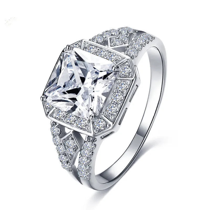 Platinum-colour zircon ring with hollow geometric quadrilateral design on a copper base