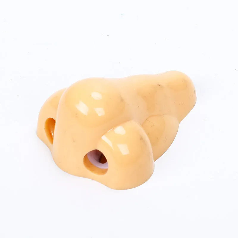 Flesh coloured plastic geometry design pencil sharpener with large casing, shown alongside a pencil.