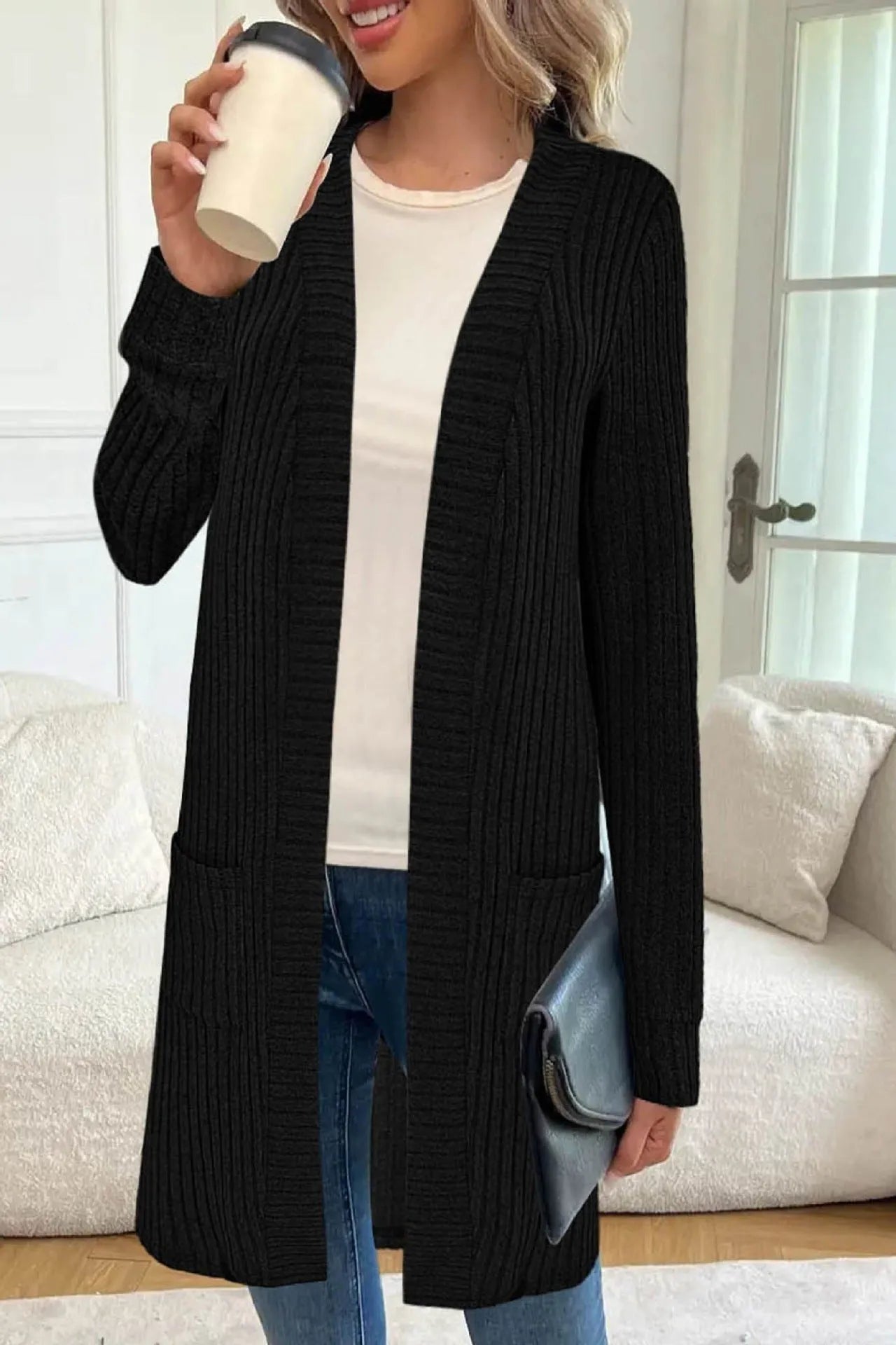 Long sleeve loose fit knitted cardigan jacket with pockets in polyester fabric.