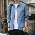 Man wearing a black Korean-style loose lapel casual jacket with zipper pockets