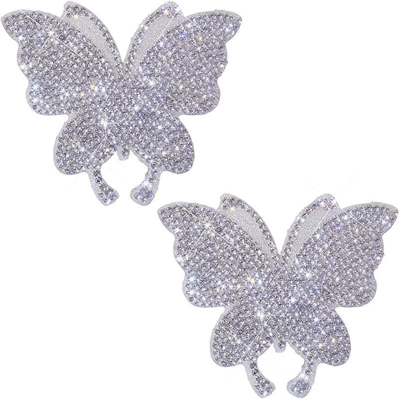 Diamond-encrusted bear paw and butterfly car sticker on vehicle surface