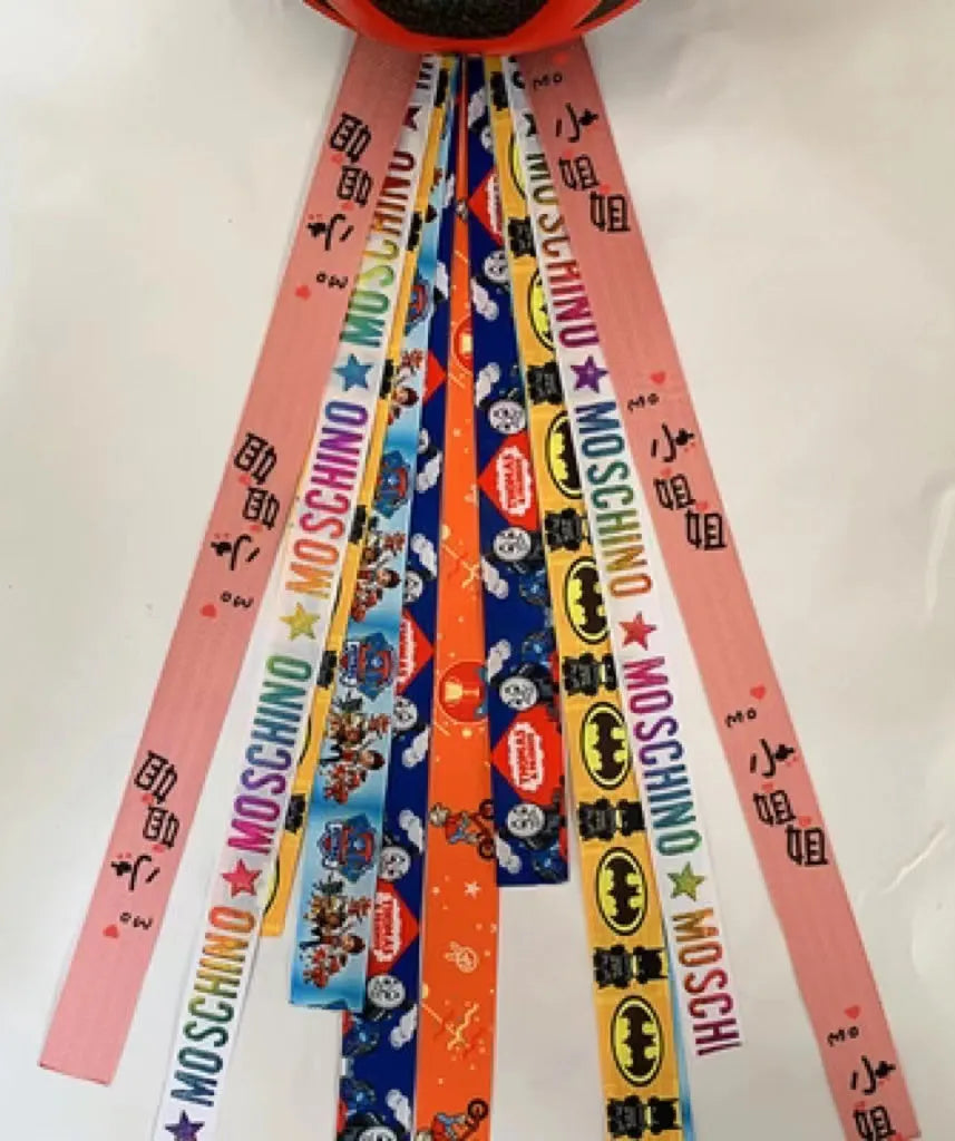 Decorative ribbon streamer for a child's ski or skating helmet in various colour options.