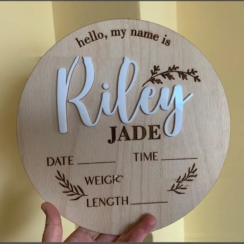 Square wooden baby name sign with engraved birth details including name, date, time, weight, and length.