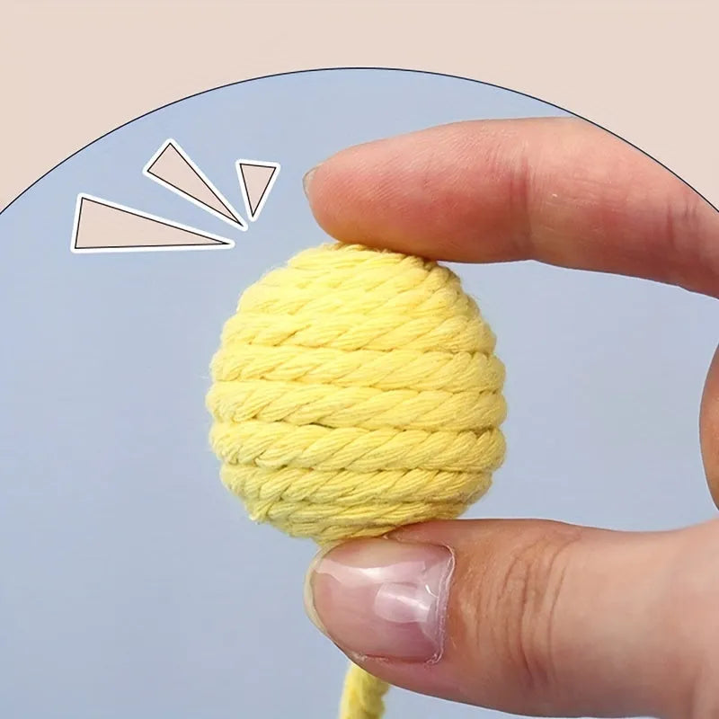 Colourful cat toy ball with rope attachment and internal bell for interactive kitten play