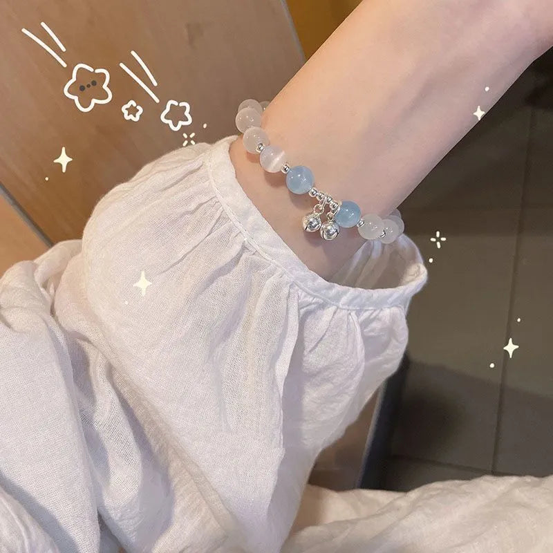 A Chinese style glass bracelet with bamboo leaf and bead designs on a wrist.