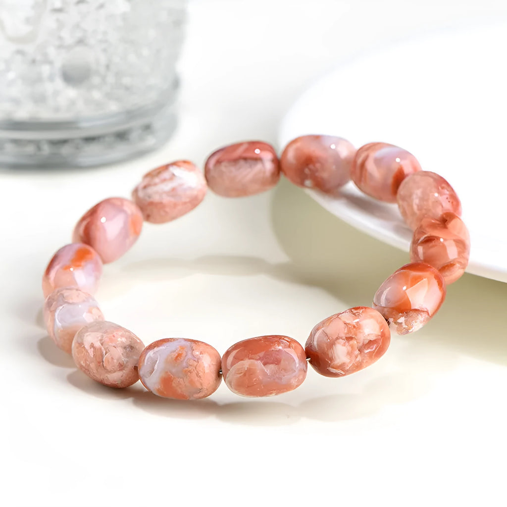 Natural cherry agate barrel bead bracelet with Ruyi design elements on wrist