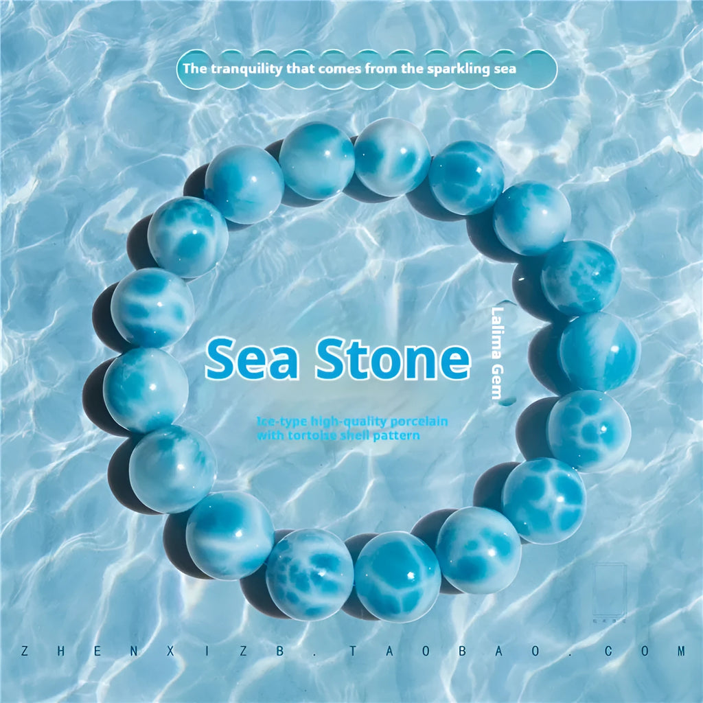Blue natural crystal sea-pattern stone and bodhi seed bracelet with pearl accents on a wrist.