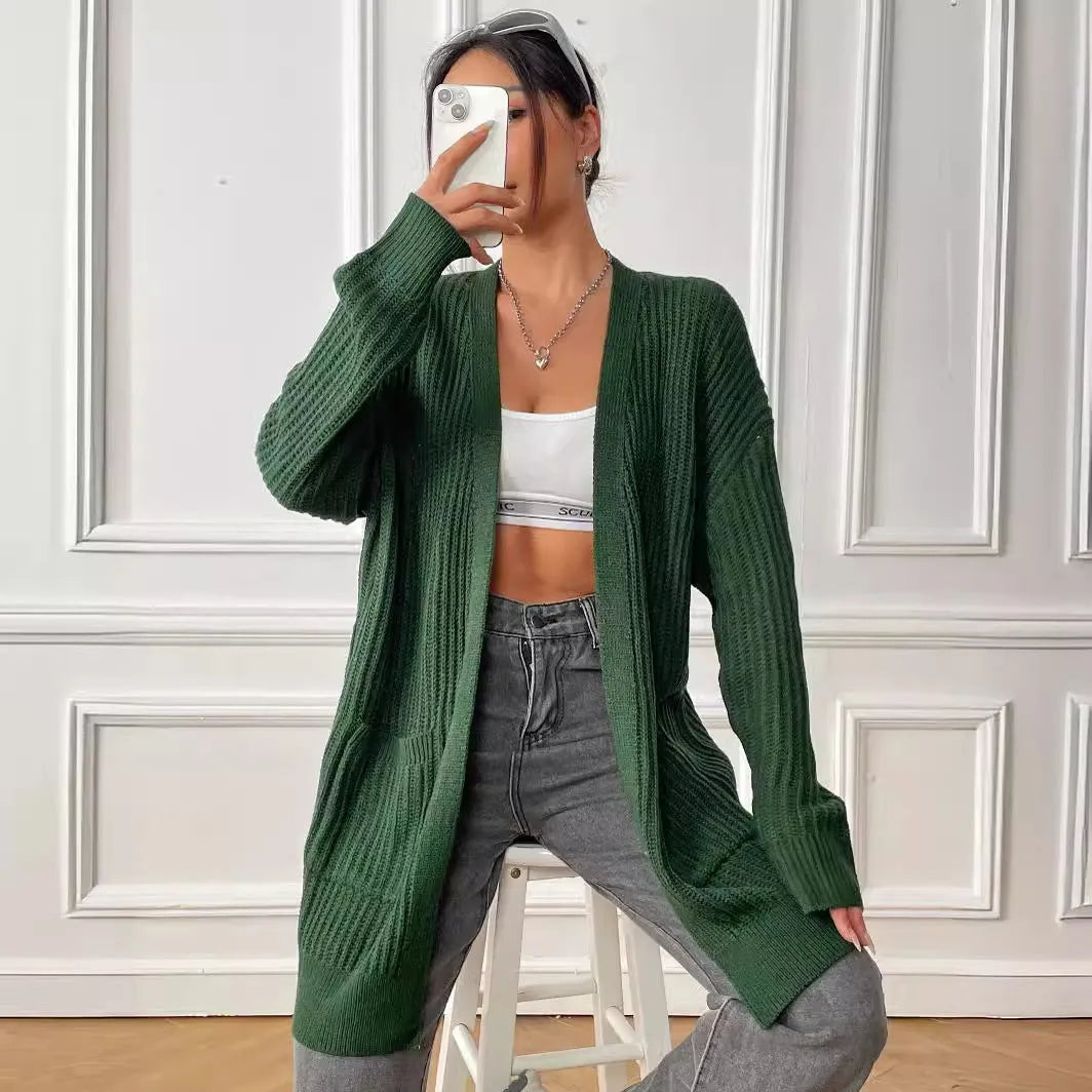 Women's dark green acrylic cardigan with two front pockets and long sleeves on a hanger.