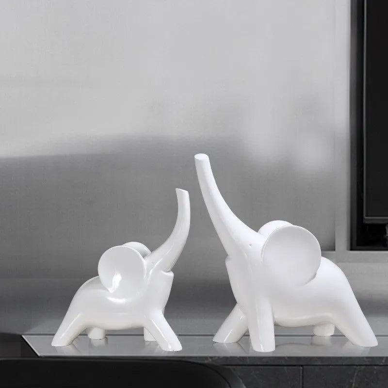 Rose gold and white resin elephant ornaments in large and small sizes displayed singly and as pairs