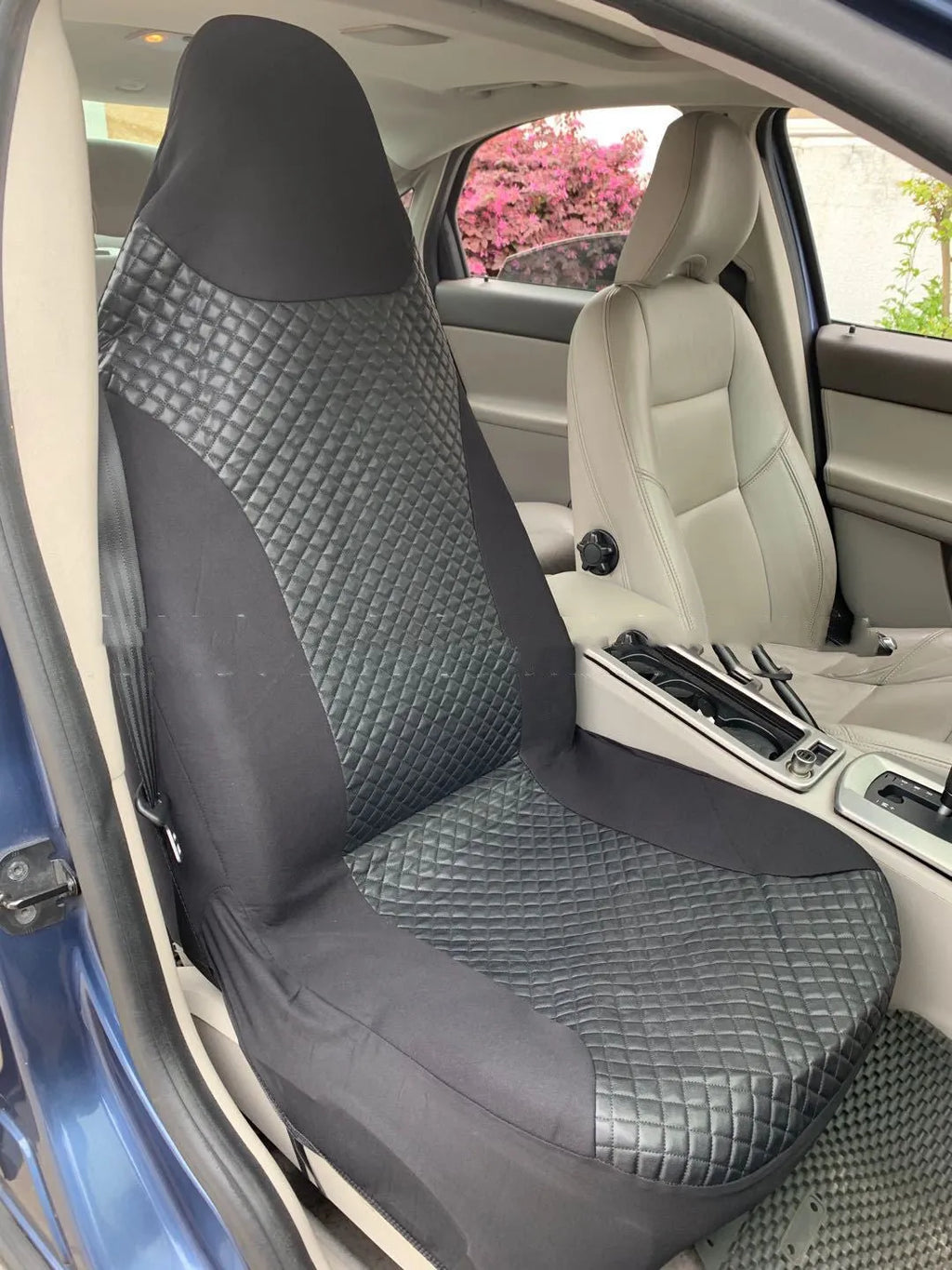 Black quilted automotive seat covers showing PU and polyester fabric construction with plastic hook fasteners
