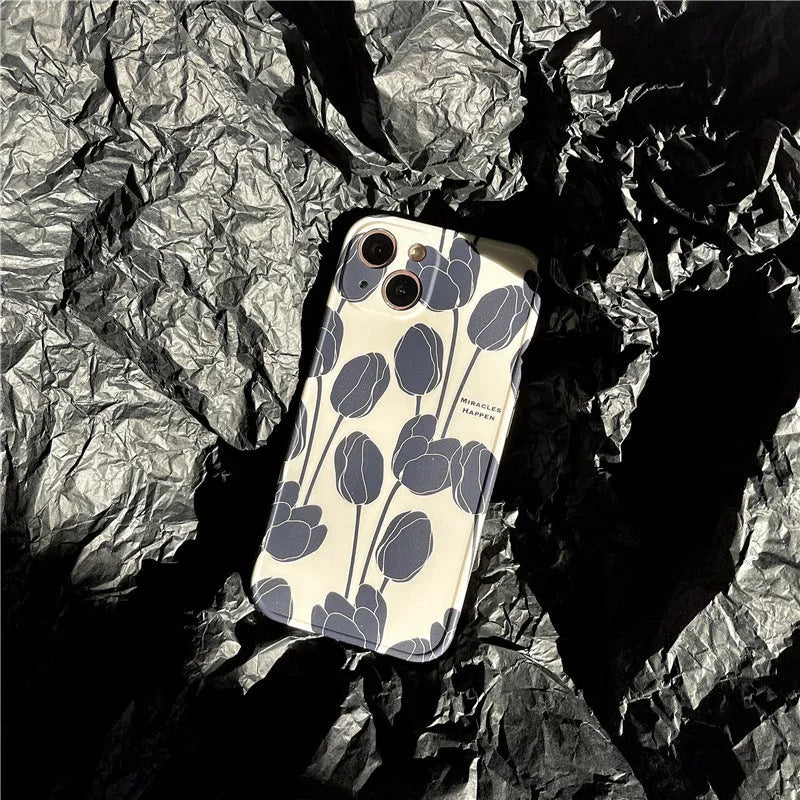 Black silicone iPhone case with a large tulip flower design on the back.
