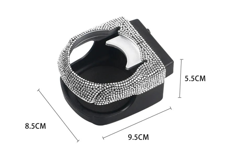 Sparkling rhinestone car cup holder bracket clipped to a vehicle air vent, shown in pink diamond colour.