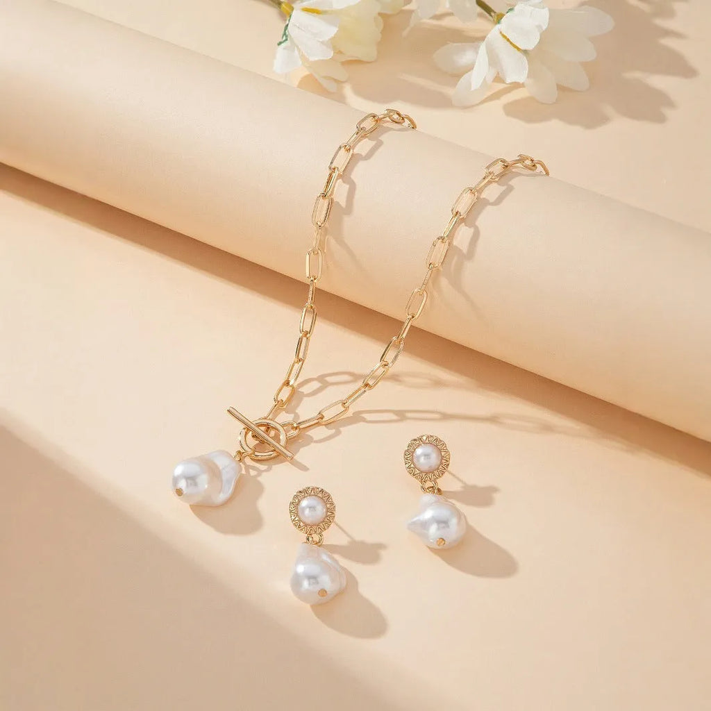 Gold tone retro baroque pearl pendant necklace and matching stud earrings set for women.