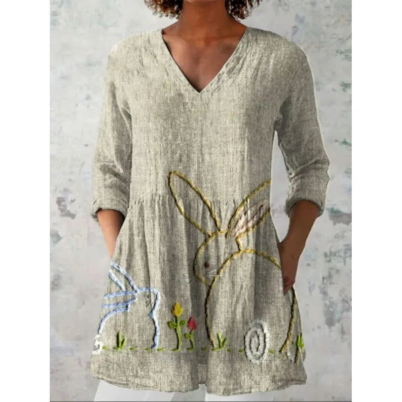 Women's loose-fit dress with a blue and white wave print, wide waist, and 3/4 length sleeves.