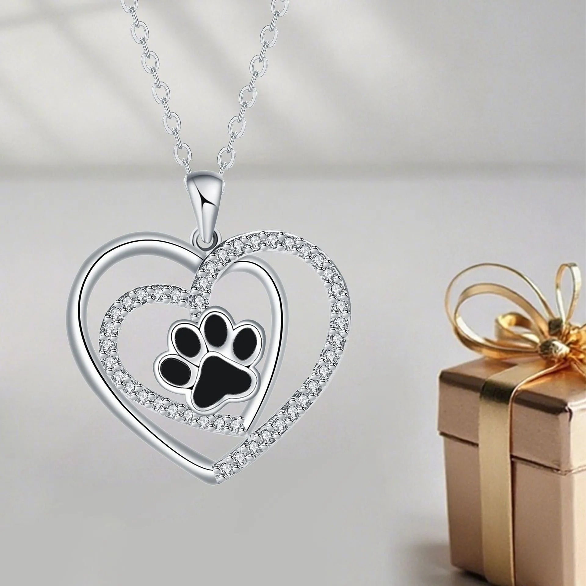 Women's dog paw footprint necklace with heart design on copper pendant and cross chain