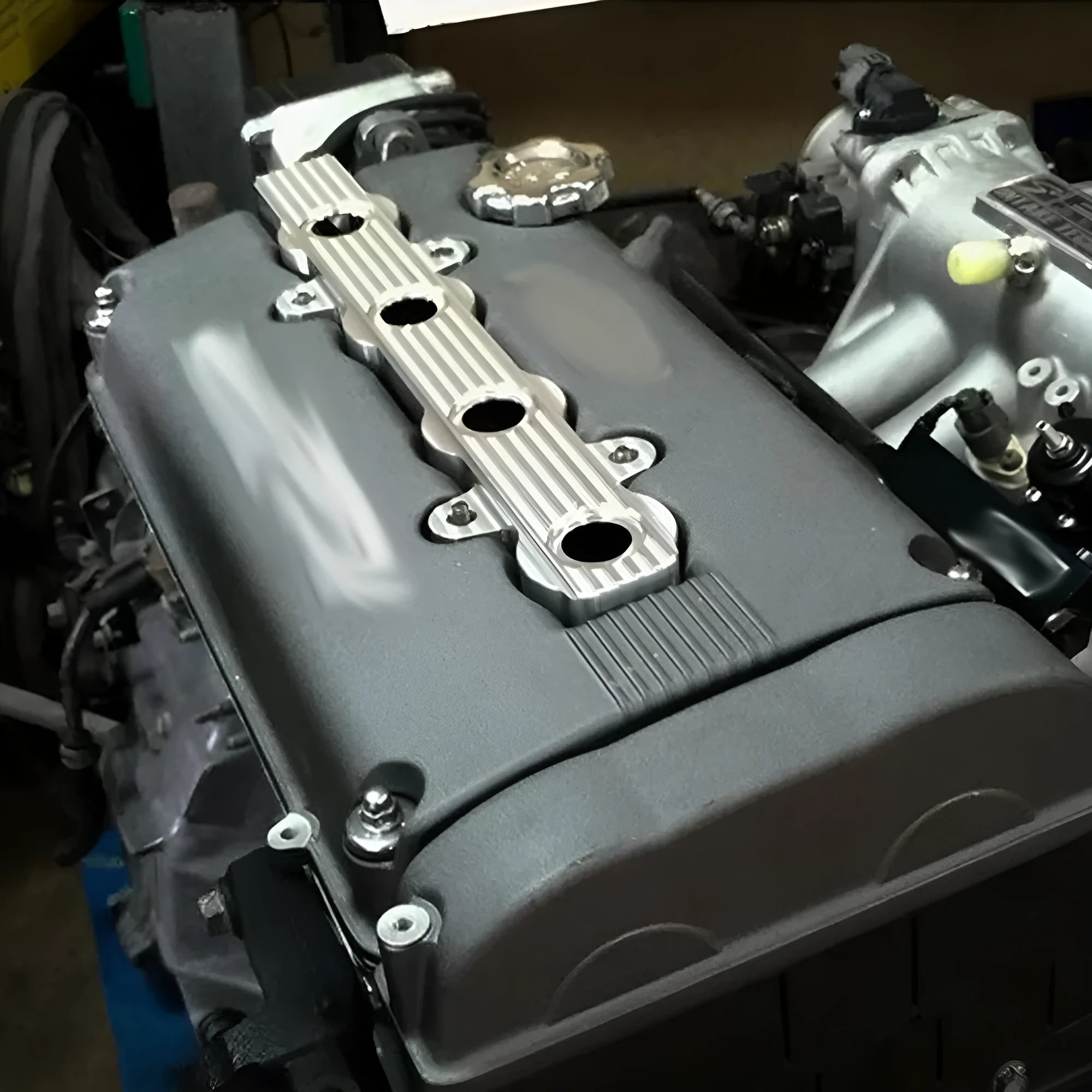 Aluminium engine harness cover in blue, red, or silver, shown with and without mounting holes.