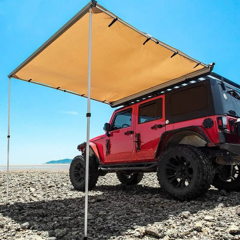 Two-room car camping tent with black glue coated fabric and aluminium poles set up outdoors.