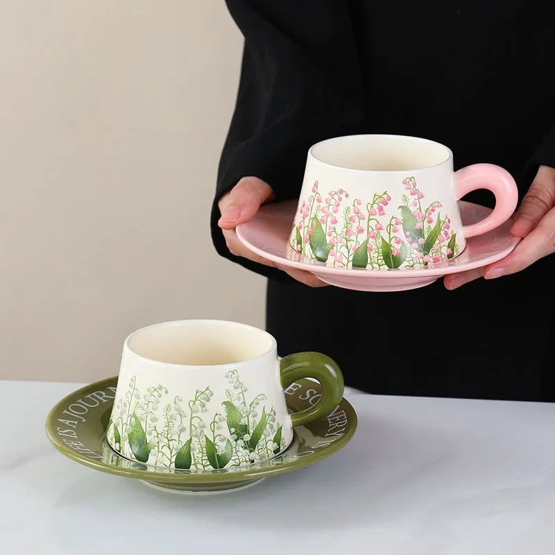 Ceramic coffee cup and saucer set for two with couple's design and stirring spoons