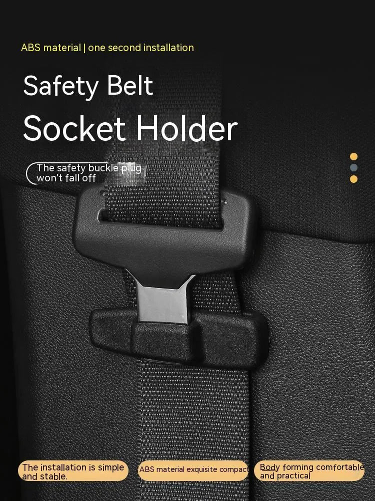 A pair of black plastic universal seat belt stopper clips on a car seat.