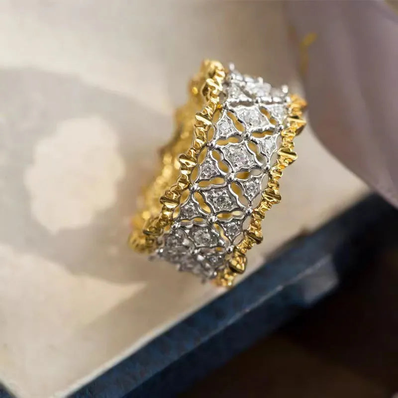 Geometric two-tone zircon ring with round elements on a copper base, shown in gold.