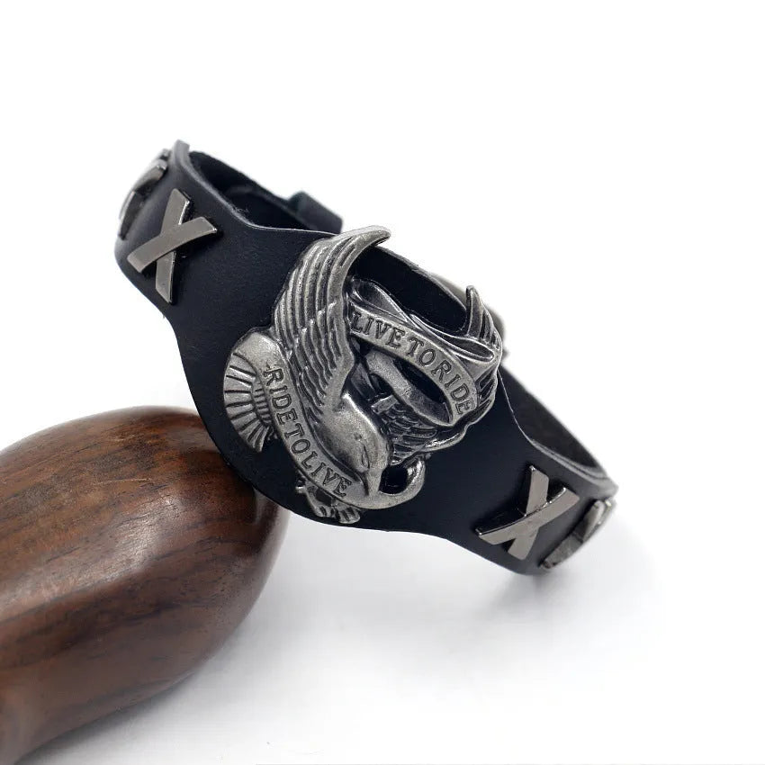 Black leather bracelet with alloy eagle watch-button clasp showing geometric patterning