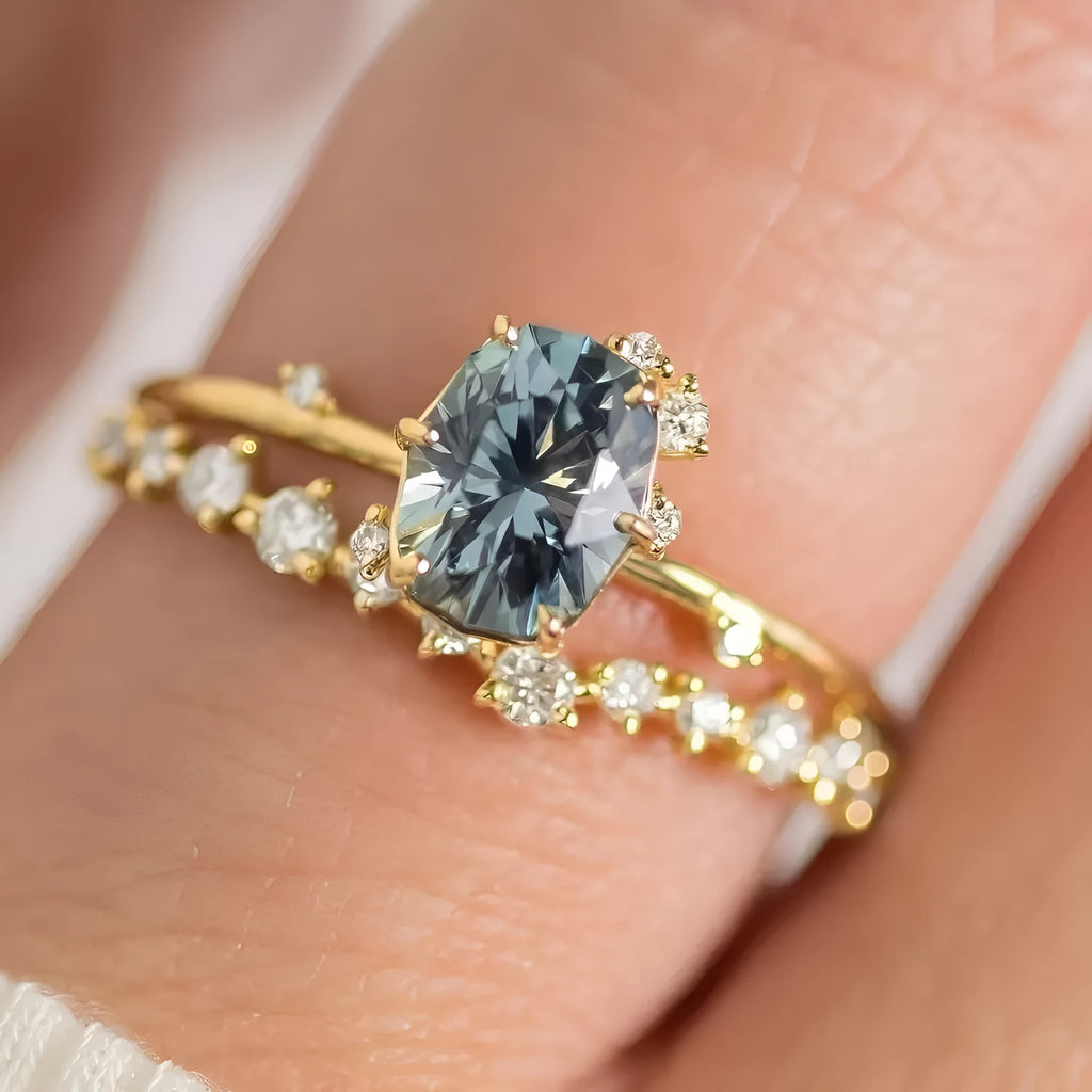 Gold-plated floral ring with a green zircon stone, shown on a finger.